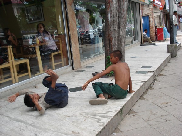 Two beggars fighting in the street