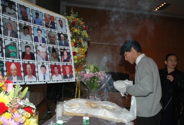 Tenzing Sherpa, son of Mingma Norbu Sherpa, offering a silk scarf to his departed dad and others' pictures. 