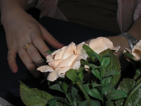 Artificial rose and the gracious hands